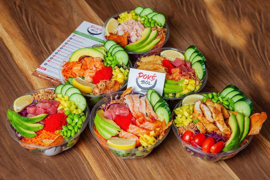 Chef preparing poke bowl in open kitchen counter at Montreal restaurant
